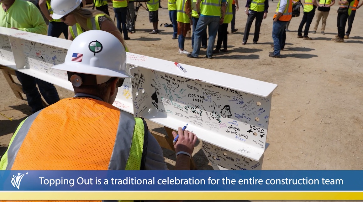  Construction worker signs steel beam